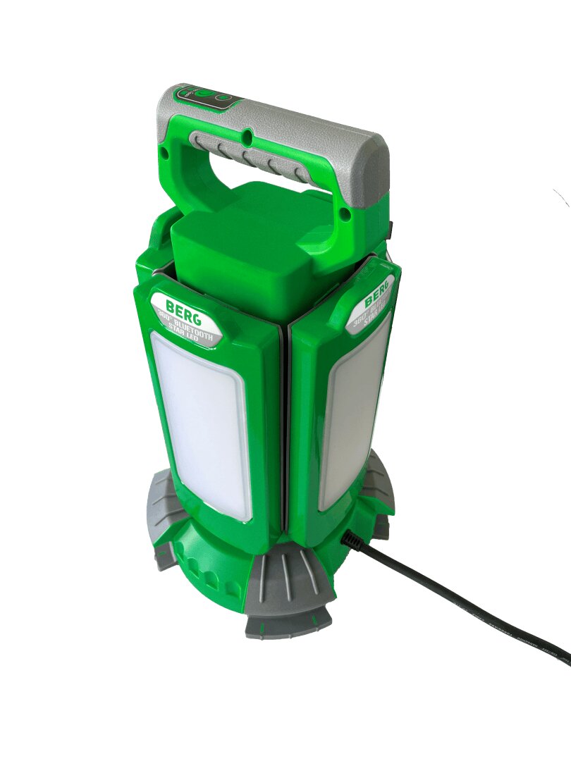 A green and gray portable LED work light with a handle on top, labeled BERG, standing upright on a round base with a power cord attached.
