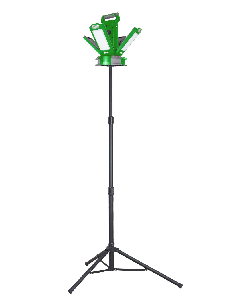 A green LED work light with adjustable panels mounted on a tall black tripod stand, isolated on a white background.