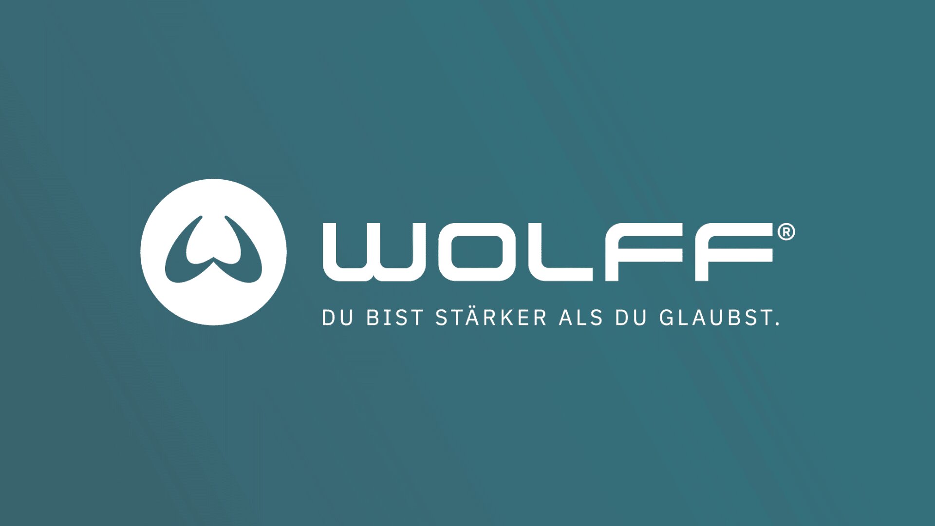 Logo for Wolff featuring a stylized white wolf head in a circle, with bold text WOLFF® and the slogan DU BIST STÄRKER ALS DU GLAUBST. on a teal background.