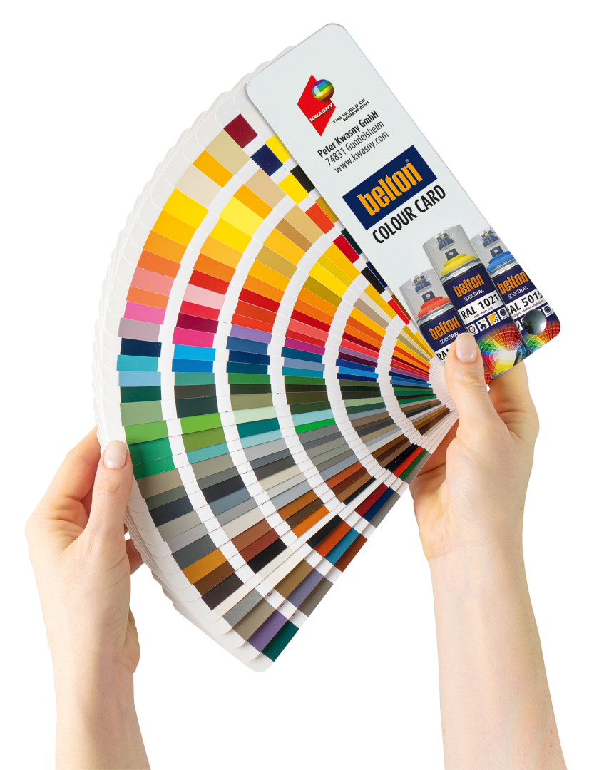 Two hands hold a fan of color swatches, displaying a wide range of colors for paint selection. The swatches are labeled “belton COLOUR CARD” and feature paint cans on the cover card.