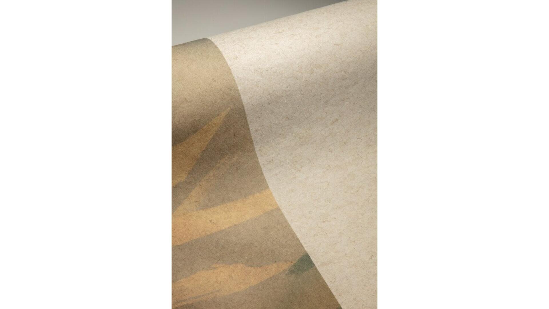 A close-up of a textured, beige paper with a soft, abstract pattern in muted brown and tan tones, featuring curved and angled shapes. The paper appears to be slightly curled at the edge.