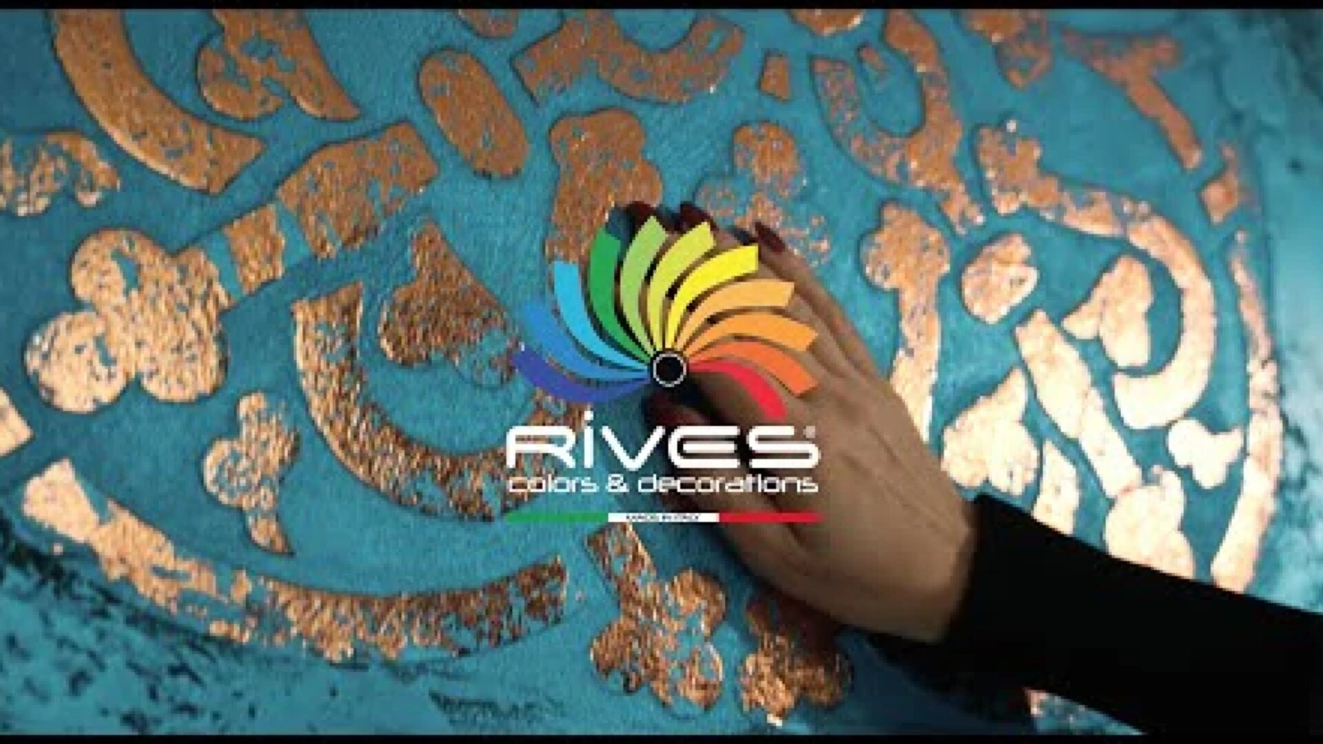A hand touches a textured, metallic gold pattern on a bright blue surface. The logo Rives Colors & Decorations with a colorful swirl is centered over the image.