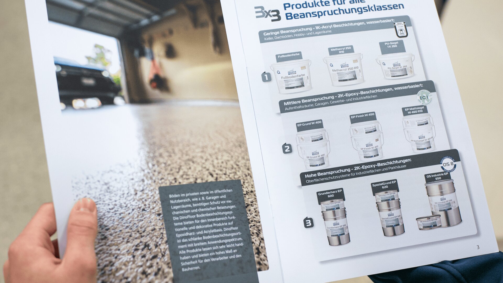 A person holds a brochure showing close-up flooring and a product guide with images of paint cans, descriptions, and headings in German related to coatings for different durability levels.