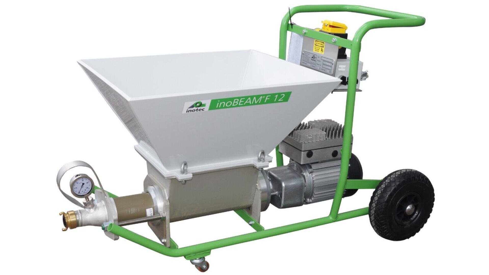 A green and white industrial mortar or plaster pump machine labeled inoBEAM F12 with a large hopper, pressure gauge, and two wheels for mobility.